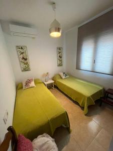 a room with two beds and a window at Casa Marieta in Benissa