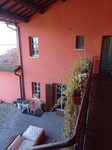 a balcony of a house with a red wall at Il Casale di Giulia di Aprilia in Aprilia