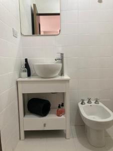 a white bathroom with a sink and a toilet at Pacífico Il in Cordoba