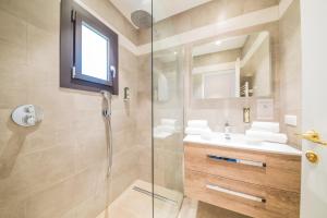 a bathroom with a glass shower and a sink at Hotel Brin d'Azur - Saint Tropez in Saint-Tropez