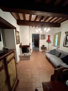 a living room with a couch and a fireplace at Casa Banino in Cagli