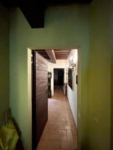 a hallway in a house with green walls and a door at Casa Banino in Cagli