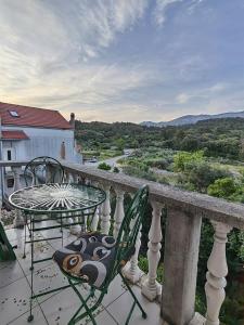 a table and chairs on a balcony with a view at Apartments Vejo in Korčula