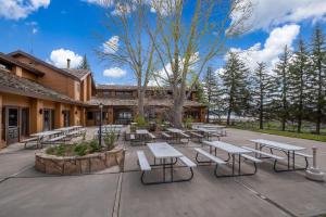 a group of tables and benches in a courtyard at Thousand Trails Blue Mesa Recreational Ranch in Hierro