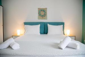 a bedroom with a bed with two pillows on it at Gerolimin Blue in Gerolimenas