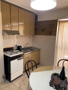 uma pequena cozinha com um fogão e uma mesa em Pacífico Il em Córdova
