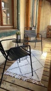 - deux chaises et une table sur une terrasse couverte dans l'établissement NOMO 2 Zimmer Altstadt Apartment Villingen im Schwarzwald, à Villingen-Schwenningen
