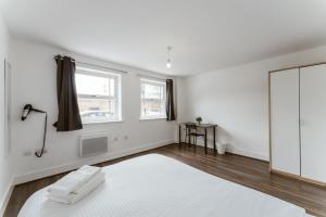 a white room with a mirror and a white rug at LimeHouse Double Rooms - 3 in London