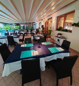 a large dining room with tables and chairs at Hotel Luisa in Brenzone sul Garda