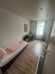 a bedroom with a bed and a desk in it at Pension Sonnenschein in Halle an der Saale