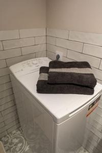 a white washing machine with a towel on top of it at El Medano cerca del mar in El Médano