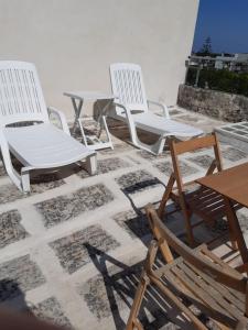 un groupe de chaises et de tables sur un toit dans l'établissement La Pizzica, à Cannole