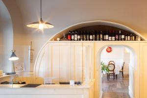 a kitchen with an archway with wine bottles at Palazzo Matà Boutique Hotel in Taranto