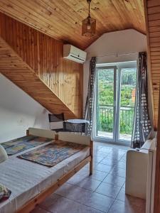 a bedroom with a bed and a large window at Apartments Vejo in Korčula