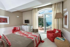a living room with a bed and a couch at Hotel Della Piccola Marina in Capri +37 photos