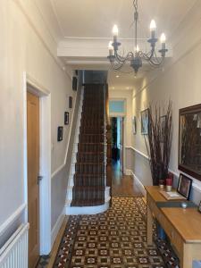 a hallway with a staircase in a house at Tranquil Garden View Double Room in London