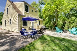 a patio with a table and chairs and an umbrella at 1 Mi to Indiana Dunes Natl Park Home with Patio! in Gary