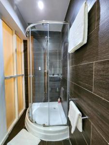 a bathroom with a shower and a tub at Villa das Arábias Boutique Hotel in Maputo