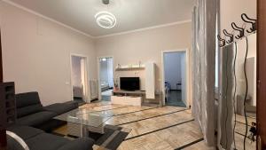 a living room with a couch and a tv at Edens house con parcheggio privato in Rapallo