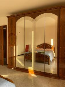 Villa Hoara في غوريزيا: غرفة نوم مع خزانة خشبية كبيرة مع أبواب زجاجية
