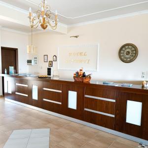 a pharmacy counter in a room with a clock on the wall at Hotel Agnanti Unique Hospitality in Kastoria