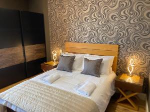 a bedroom with a white bed with two night stands at Halvard Apartments at Castletown in Castletown