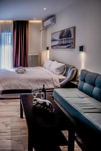 a hotel room with two beds and a couch at Diamond Suites 32 in Thessaloniki