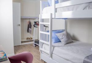 a bedroom with two bunk beds and a chair at Departamento Amoblado in Lima