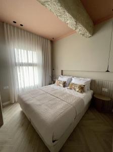 1 dormitorio con 1 cama blanca grande y 2 almohadas en 402 - GoodHouse Hillel St en Jerusalén