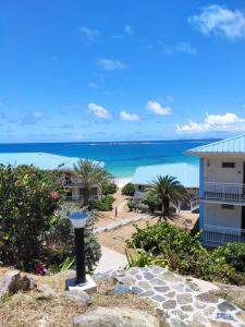a view of the beach from the balcony of a resort at Appartement Luxe Ocean View 9403 in Cul de Sac