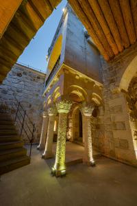 a building with columns and a staircase in a building at Janus Cappadocia Hotel in Nevsehir