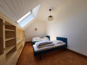 2 Betten in einem Zimmer mit Fenster in der Unterkunft Maison de caractère / Petit Versailles Normand in Valognes
