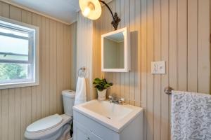 a bathroom with a sink and a toilet and a mirror at Historic Poughkeepsie Home Near Arlington & Vassar in Poughkeepsie +32 photos