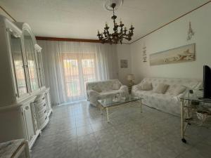 a living room with a couch and a table at CASE DEL MAR nel centro storico in Santa Teresa Gallura