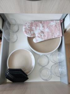 un tavolo bianco con piatti, ciotole e bicchieri di Hubane 3-toaline korter Roiul 