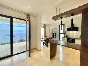 a kitchen and dining room with a view of the ocean at Family Vacation Villa Rezevici in Budva