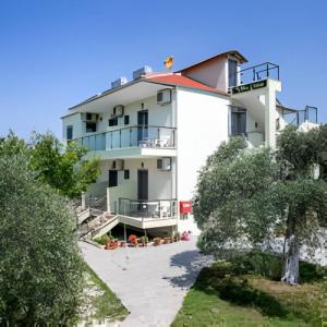 a large white building with trees in front of it at Villa Elista in Astris