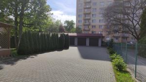 a driveway with a fence next to a building at Apartmány TriMM in Uherské Hradiště