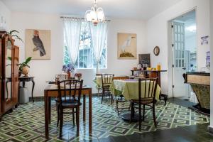 a dining room with a table and chairs at Stella Bed & Breakfast in Mexico City