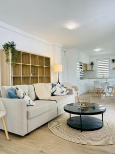 a living room with a couch and a table at Dendro Apartment in Cluj-Napoca