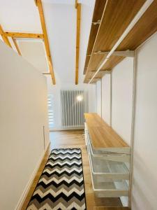 a room with a hallway with a desk and a rug at Dendro Apartment in Cluj-Napoca