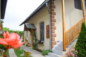 a house with stairs and flowers in front of it at Golden BIS 2, Subotica in Subotica
