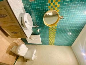 a bathroom with a toilet and a mirror at Riad Al Madina in Essaouira