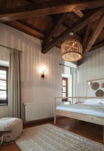 a bedroom with a large bed and a chandelier at Homstone in Nikiti