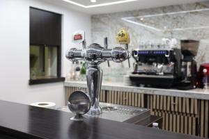 a silver mixer sitting on a counter in a kitchen at Hôtel Restaurant Clément ADER in Muret
