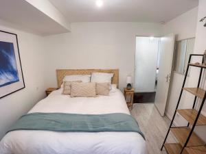 a bedroom with a bed with white sheets and pillows at Vieux Nice - Wifi, AC, 5 pers in Nice