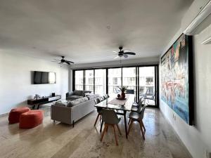 a living room with a couch and a table at New Condo with Pool, Gym, A/C, WiFi, King Size bed in Cancún