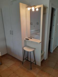 a small kitchen with a stool and a counter at St George's House in Potistika