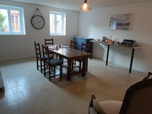 a dining room with a wooden table and chairs at A l'Ombre des Bois, Chambre double vue jardin in Neung-sur-Beuvron +3 photos