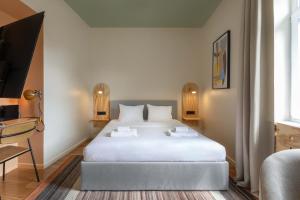 a bedroom with a large white bed in a room at Flok Tkalciceva - Main Street Rooms & Apartments in Zagreb